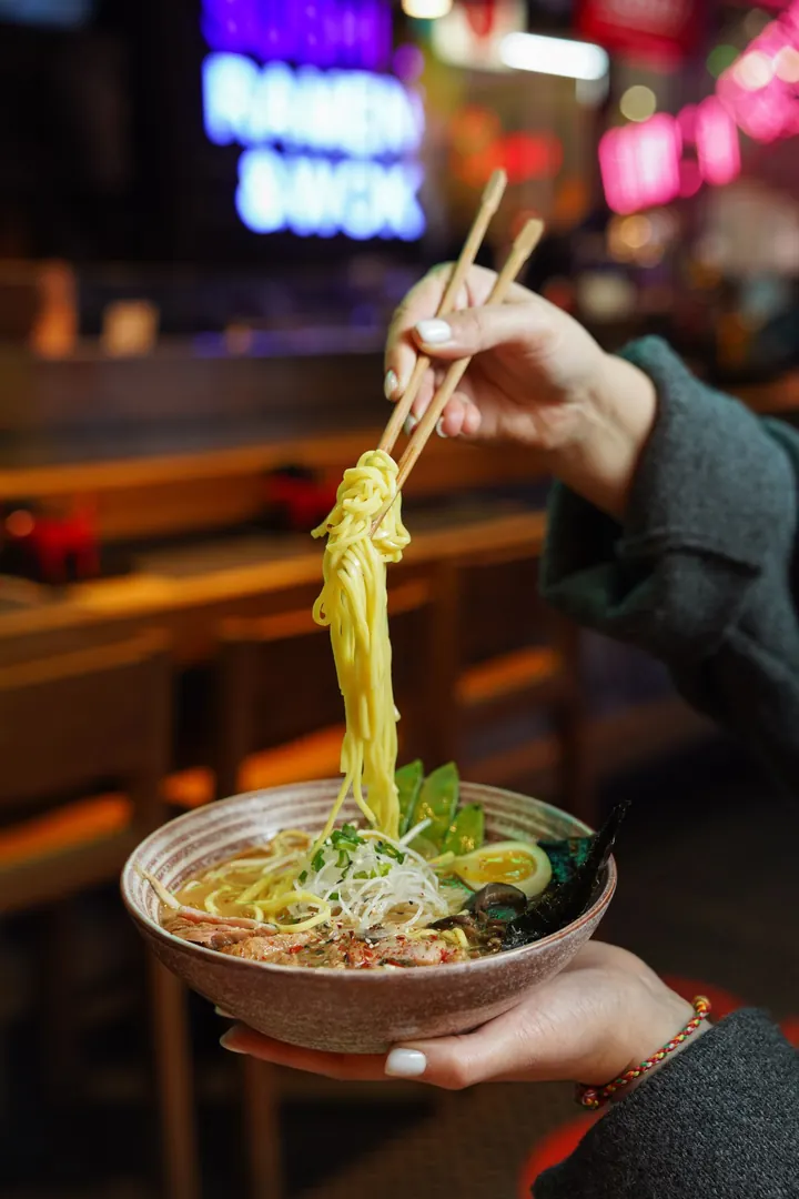 Noodles lifted from a bowl of ramen