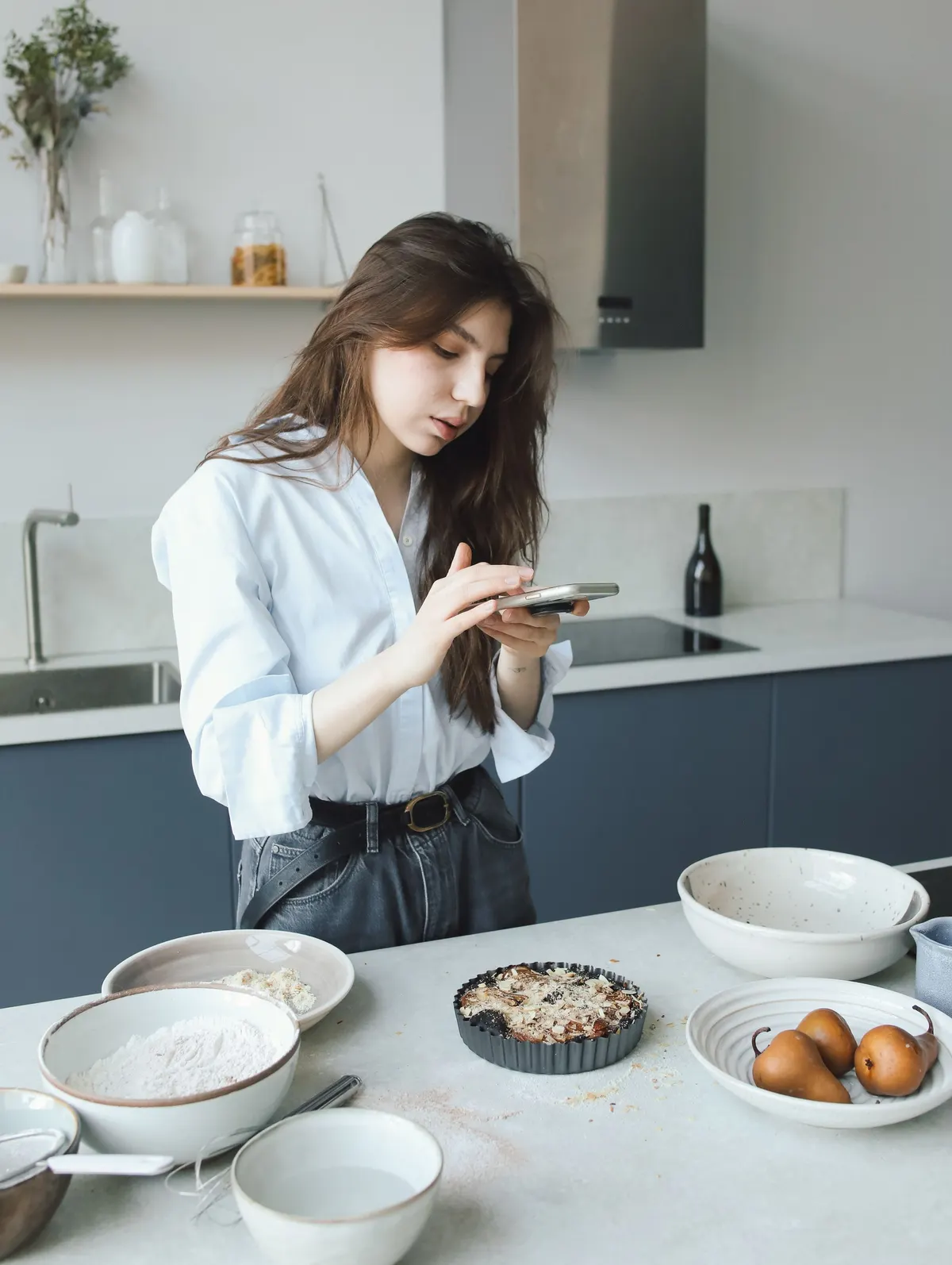 Food blogger photographing a dish with a phone