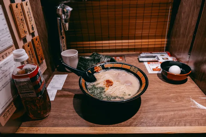 A bowl of ramen at a wooden counter