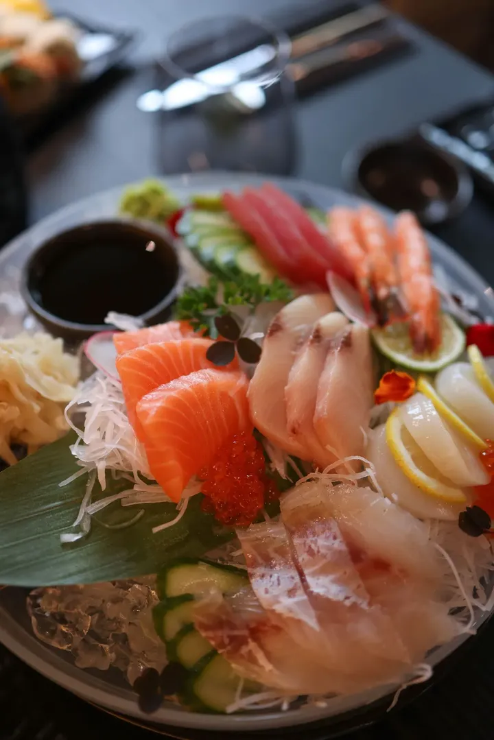 A platter of sashimi on a restaurant table
