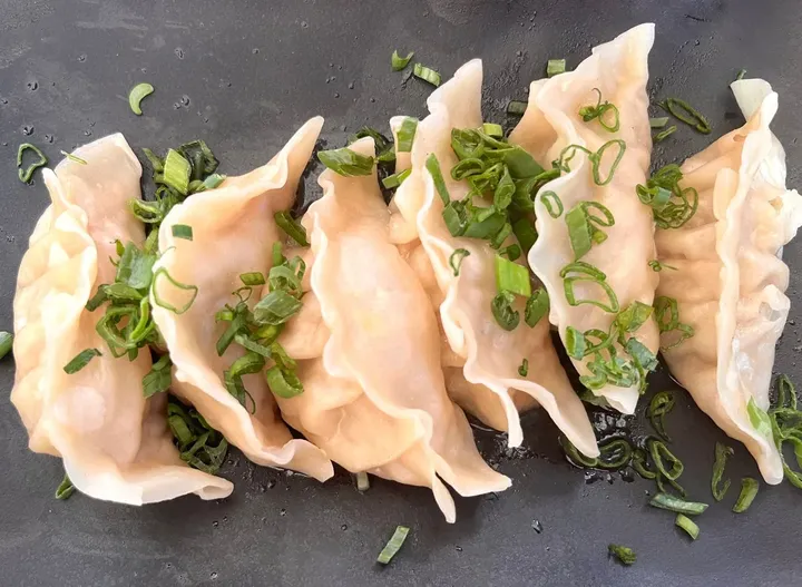 A plate of pan-fried dumplings