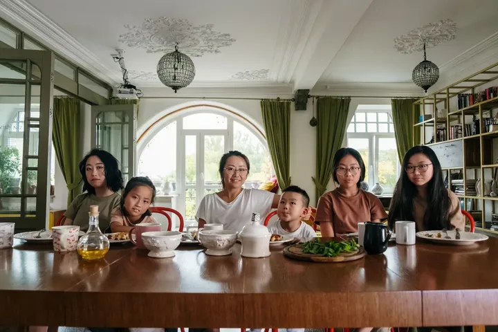 A group of friends at a long restaurant table
