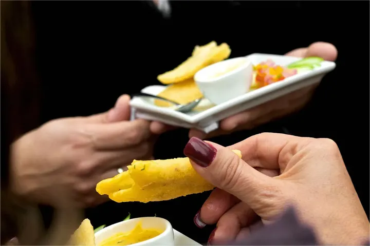 Hands passing a plate across a table