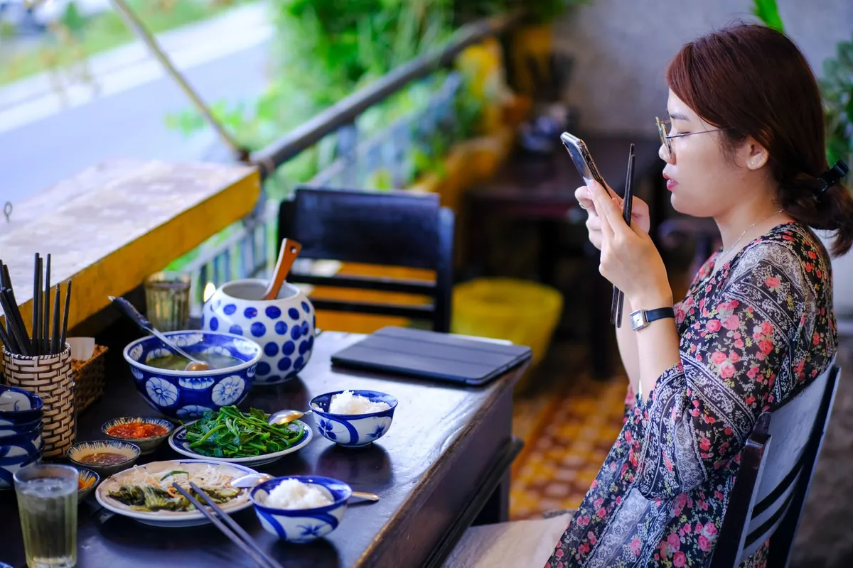 Woman filming her meal at a restaurant