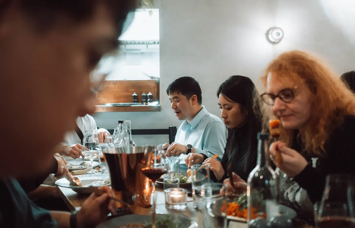 A full table of friends at dinner