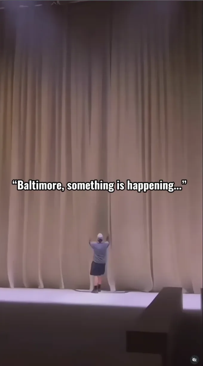 Reel 画面：员工拉开舞台幕布，字幕写着 “Baltimore, something is happening…”