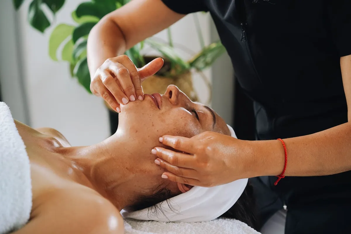 Esthetician giving a client a facial massage