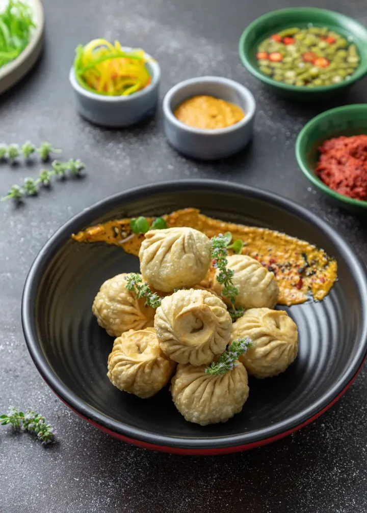 Steamed dumplings in a dark bowl